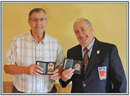 Noël Messier from Québec, former division chief of fire in Quebec City and Richard Leonardo, a former firefighter for the City of Montréal, are proud to show their badges.