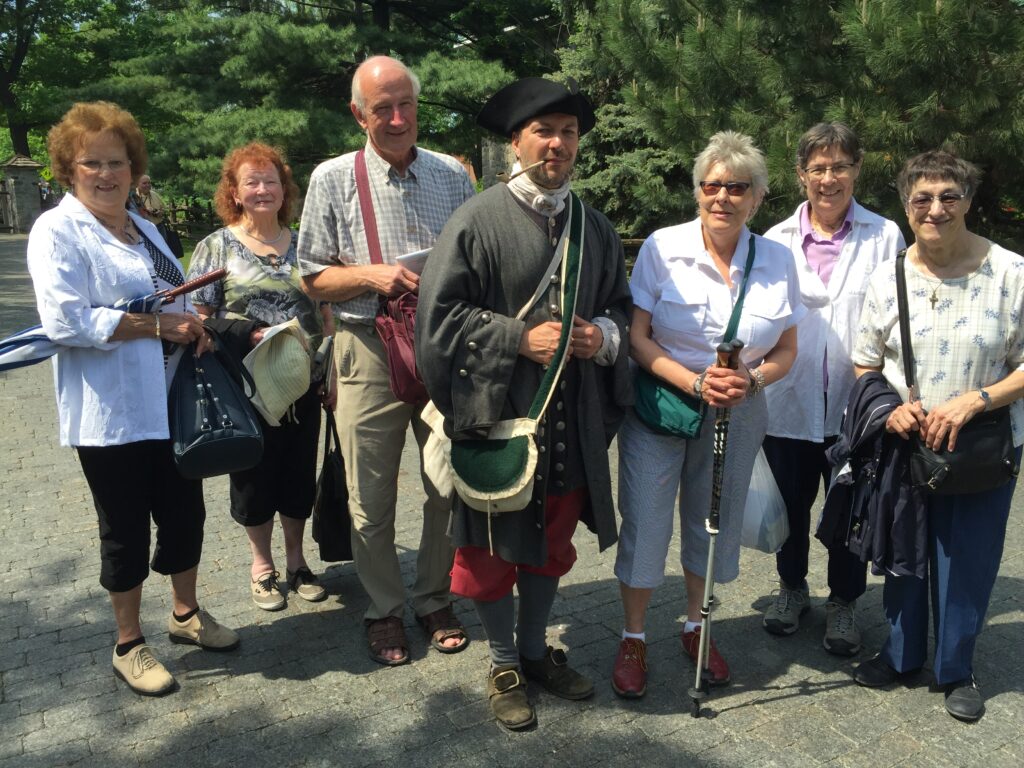 The participants surround a character in period costume.